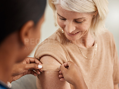 Buy stock photo Shot of a doctor giving a senior woman an injection at home