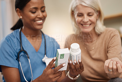Buy stock photo Shot of a doctor discussing medication options during a a consultation with a senior woman at home