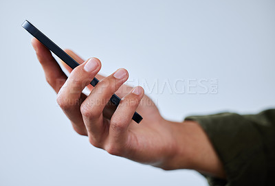 Buy stock photo Closeup shot of an unrecognisable man using a cellphone against a white background