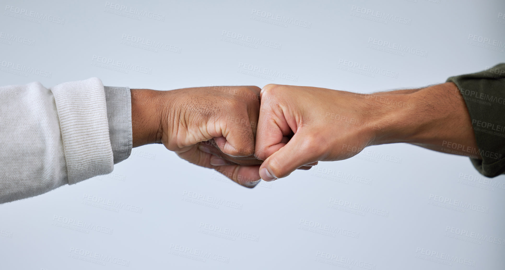 Buy stock photo Closeup shot of two unrecognisable men bumping fists against a white background