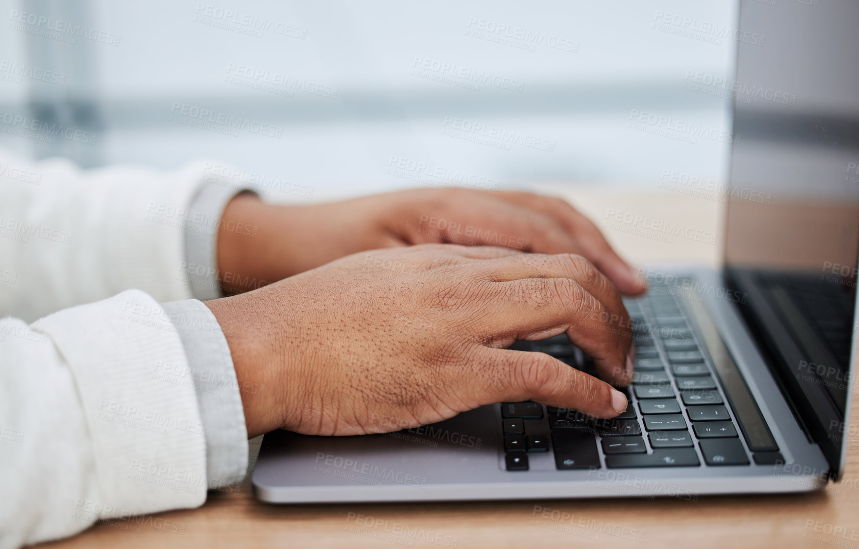 Buy stock photo Closeup shot of an unrecognisable businessman using a laptop in an office