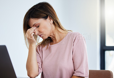 Buy stock photo Shot of a female manager experiencing a headache at work