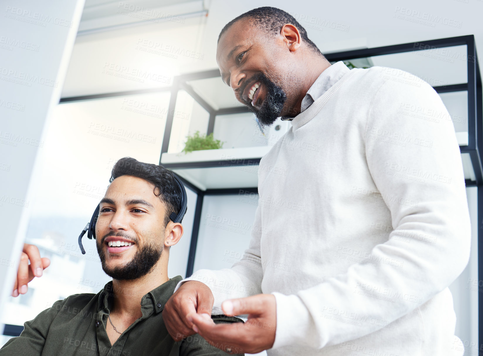 Buy stock photo Shot of a young male call center worker receiving direction from his boss