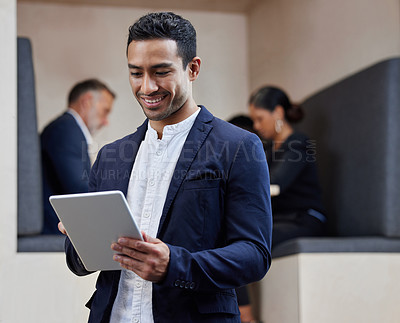 Buy stock photo Shot of a young businesswoman using his digital tablet at work