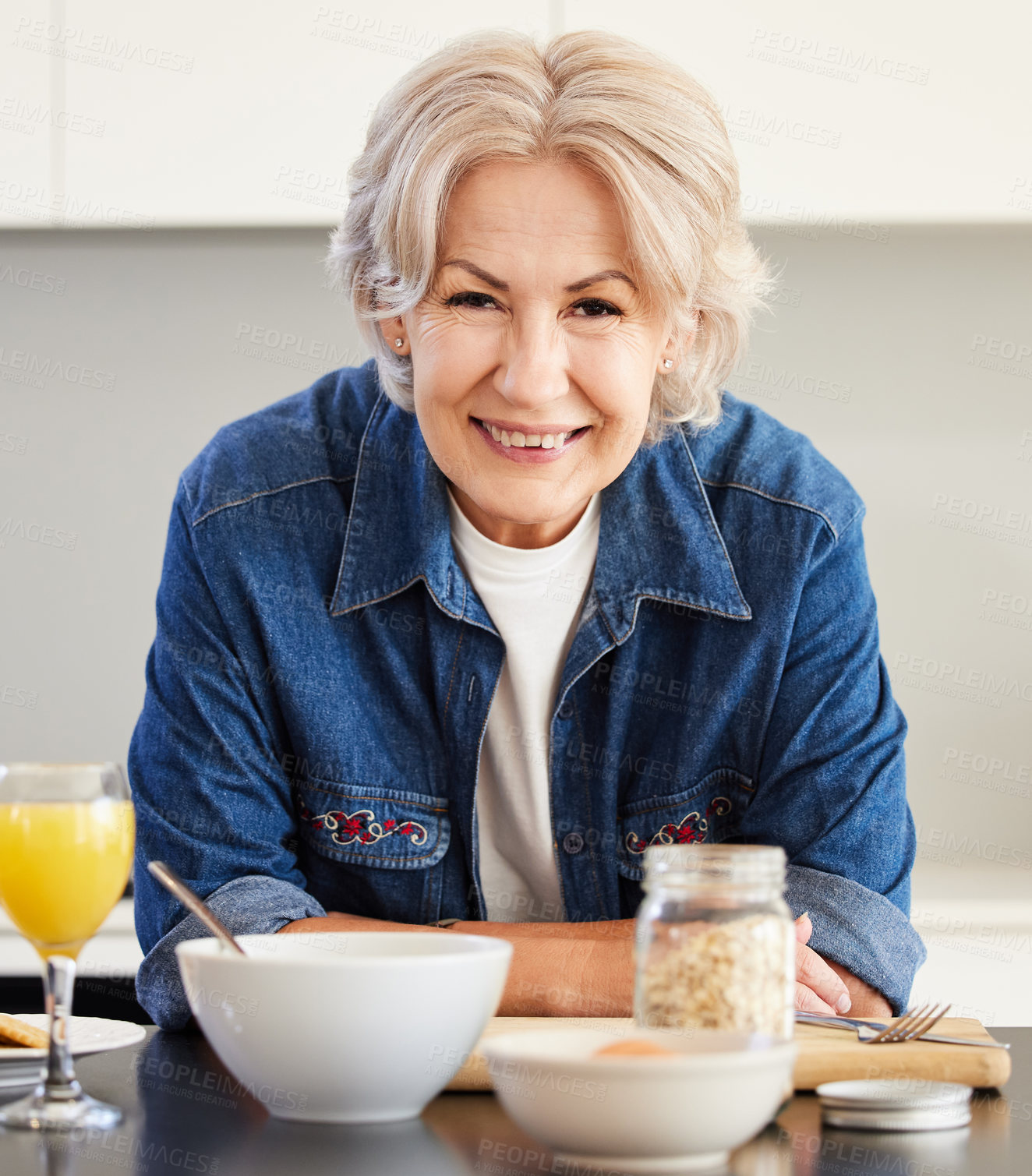 Buy stock photo Shot of a senior woman in the kitchen at home during breakfast time