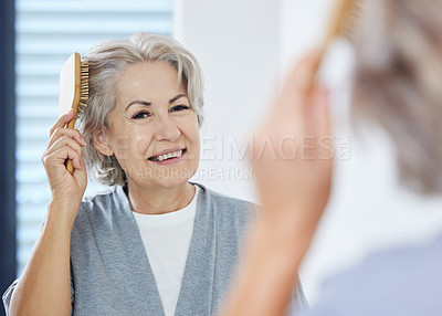 Buy stock photo Home, senior woman and comb hair in mirror for maintenance, texture and growth in bathroom. House, reflection and elderly person with hairbrush for scalp health, wellness and self care in retirement