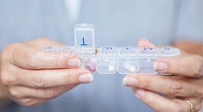 Buy stock photo Hands, container and routine healthcare with a woman in her home during retirement closeup for daily vitamins. Medicine, medical and supplements with an elderly person taking prescription medication