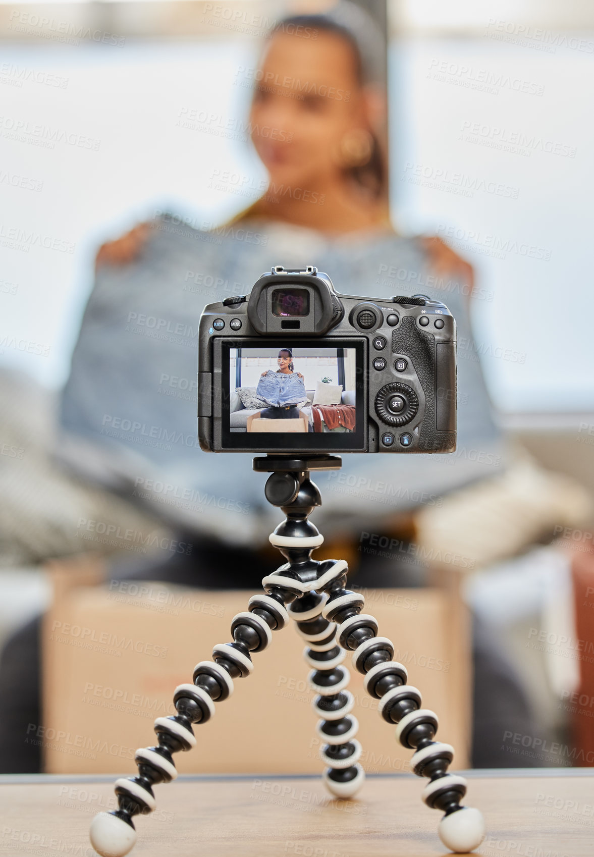 Buy stock photo Shot of a young woman recording a video for her vlog at home