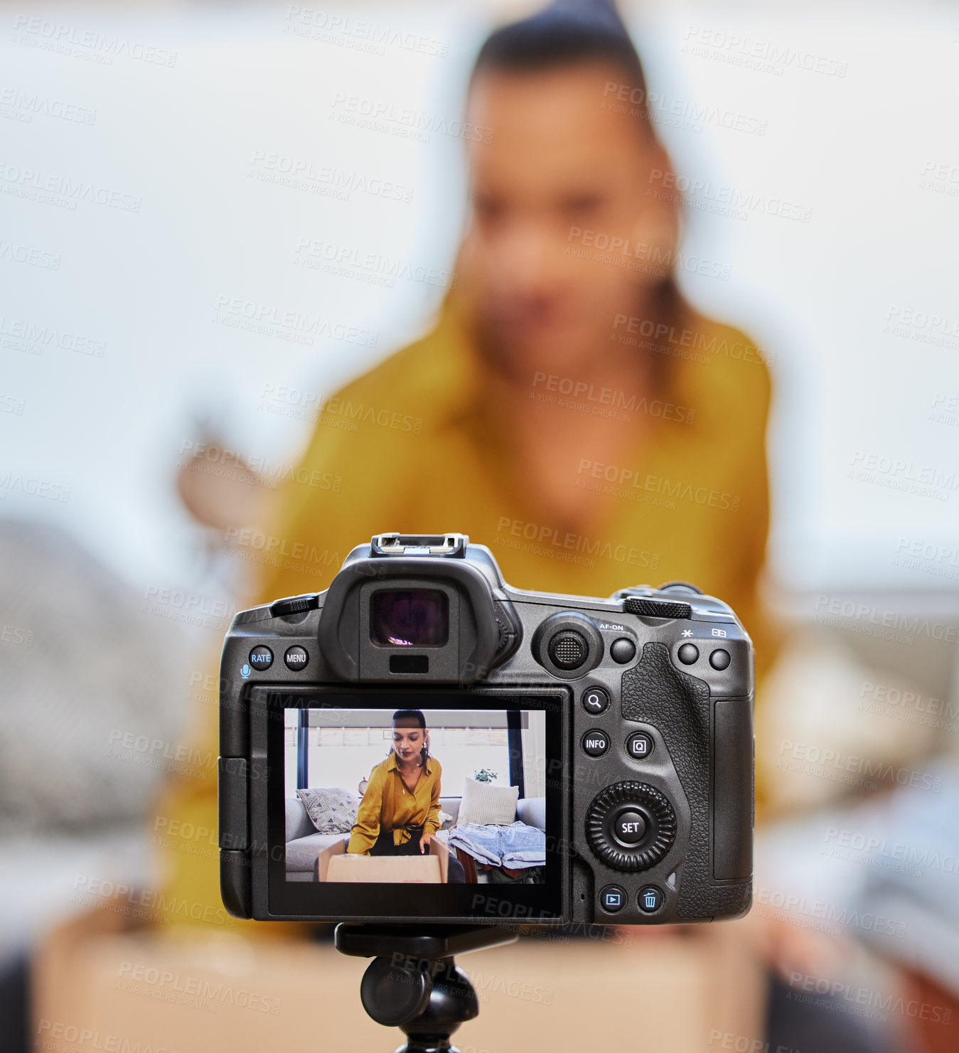 Buy stock photo Shot of a young woman recording a video for her vlog at home