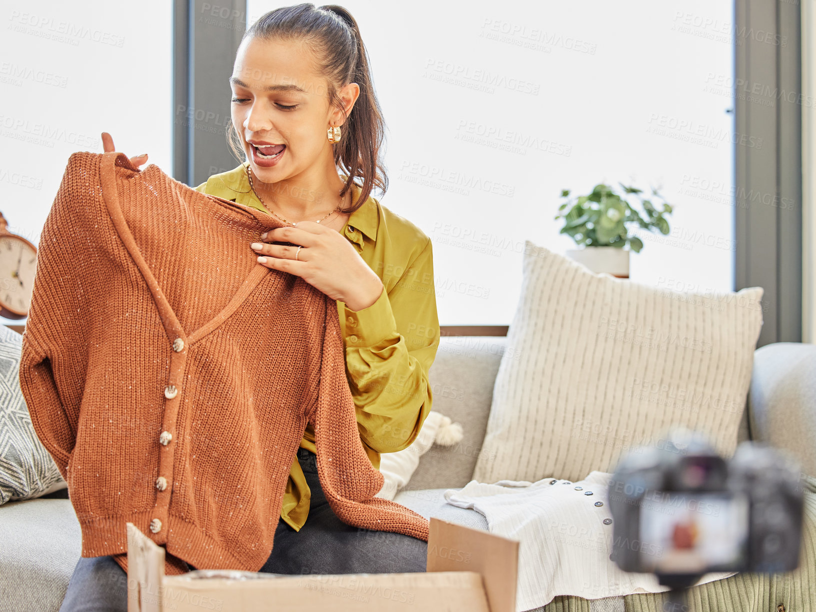 Buy stock photo Shot of a young woman recording a video for her vlog at home