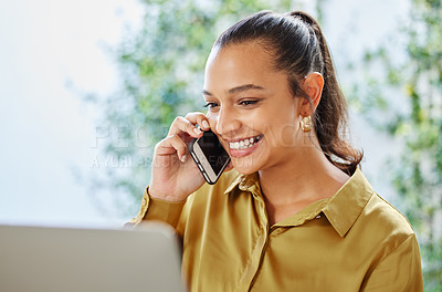 Buy stock photo Cropped shot of an attractive young woman businesswoman making a phonecall while working on her laptop at home