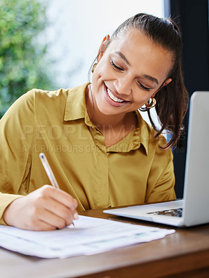 Buy stock photo Cropped shot of an attractive young businesswoman filling out paperwork while working from home