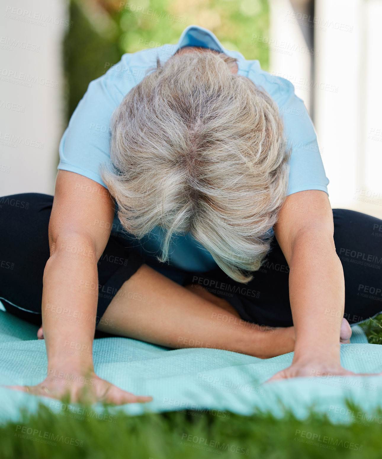 Buy stock photo Shot of a senior woman doing yoga outside in her yard