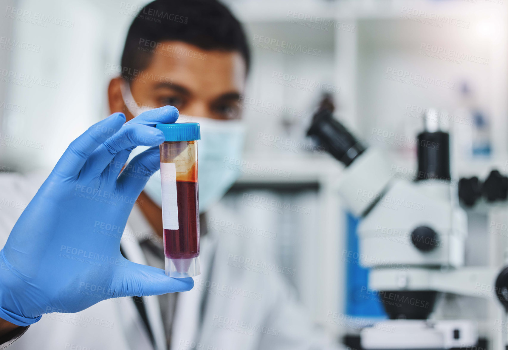 Buy stock photo Shot of a young male researcher working in a laboratory