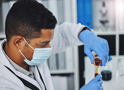 Buy stock photo Shot of a young male researcher working in a laboratory