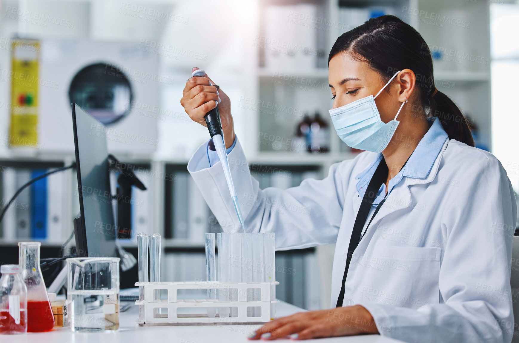 Buy stock photo Shot of a young female researcher working in a laboratory