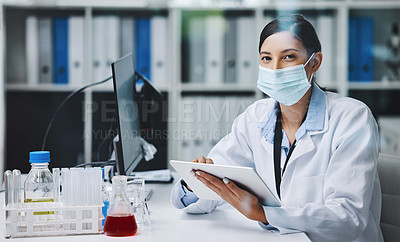 Buy stock photo Shot of a young female researcher using a digital tablet in an office at work