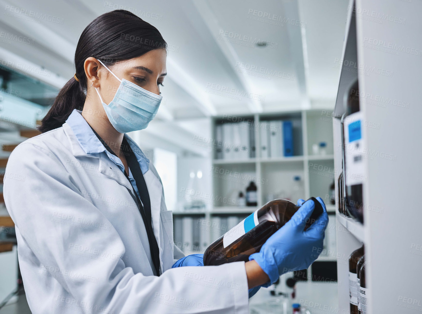 Buy stock photo Shot of a young female researcher working in a laboratory