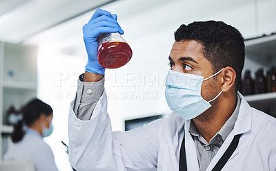 Buy stock photo Shot of a young male researcher working in a laboratory