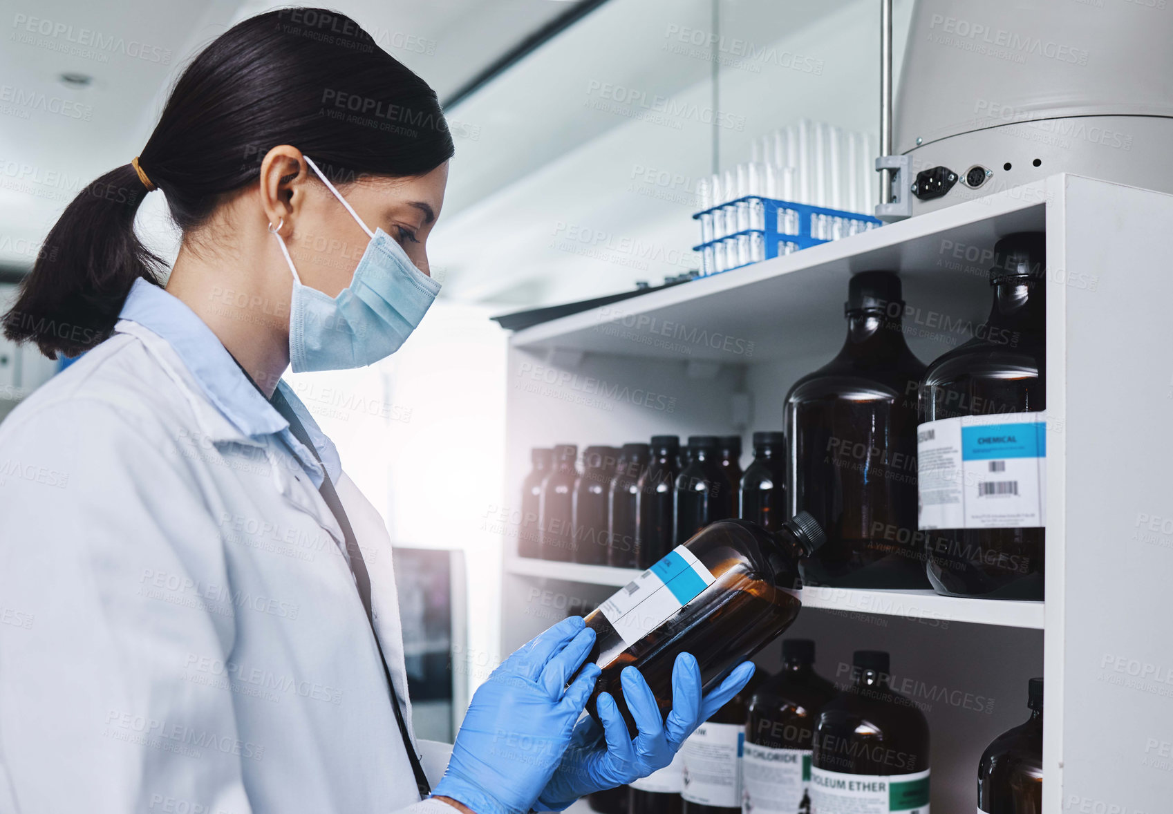 Buy stock photo Woman, scientist and chemicals in storage of lab for biotechnology research, experiment and medical safety. Doctor, glass and liquid for study, solution or equipment of chemistry test for health
