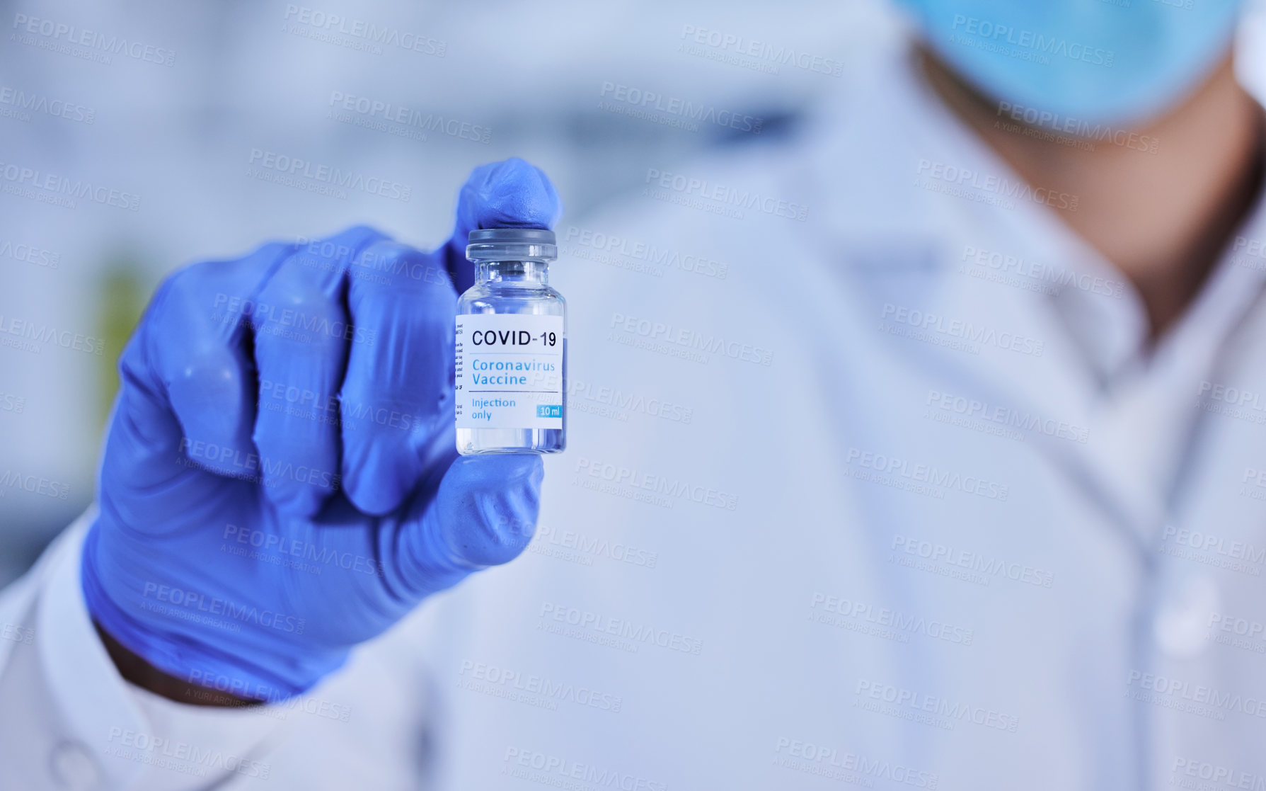 Buy stock photo Cropped shot of an unrecognizable scientist holding up a bottle of the covid 19 vaccine