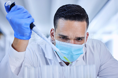Buy stock photo Cropped shot of a handsome young male scientist working in his lab