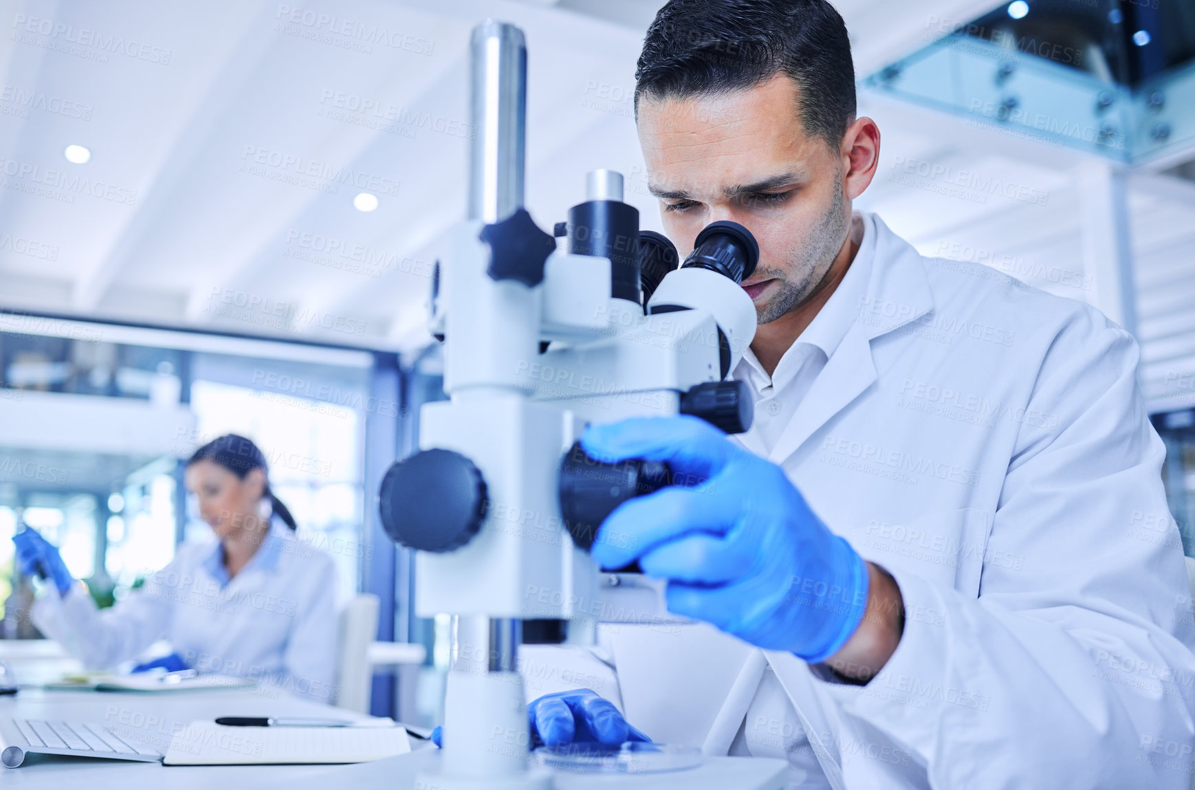 Buy stock photo Microscope, man and scientist with research in lab, tech and tablet for report of results and observe. Medical, science and person in pharmacy, healthcare and check for medicine, test or innovation