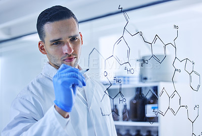 Buy stock photo Cropped shot of a handsome young male scientist working on a glass wipe board in his lab