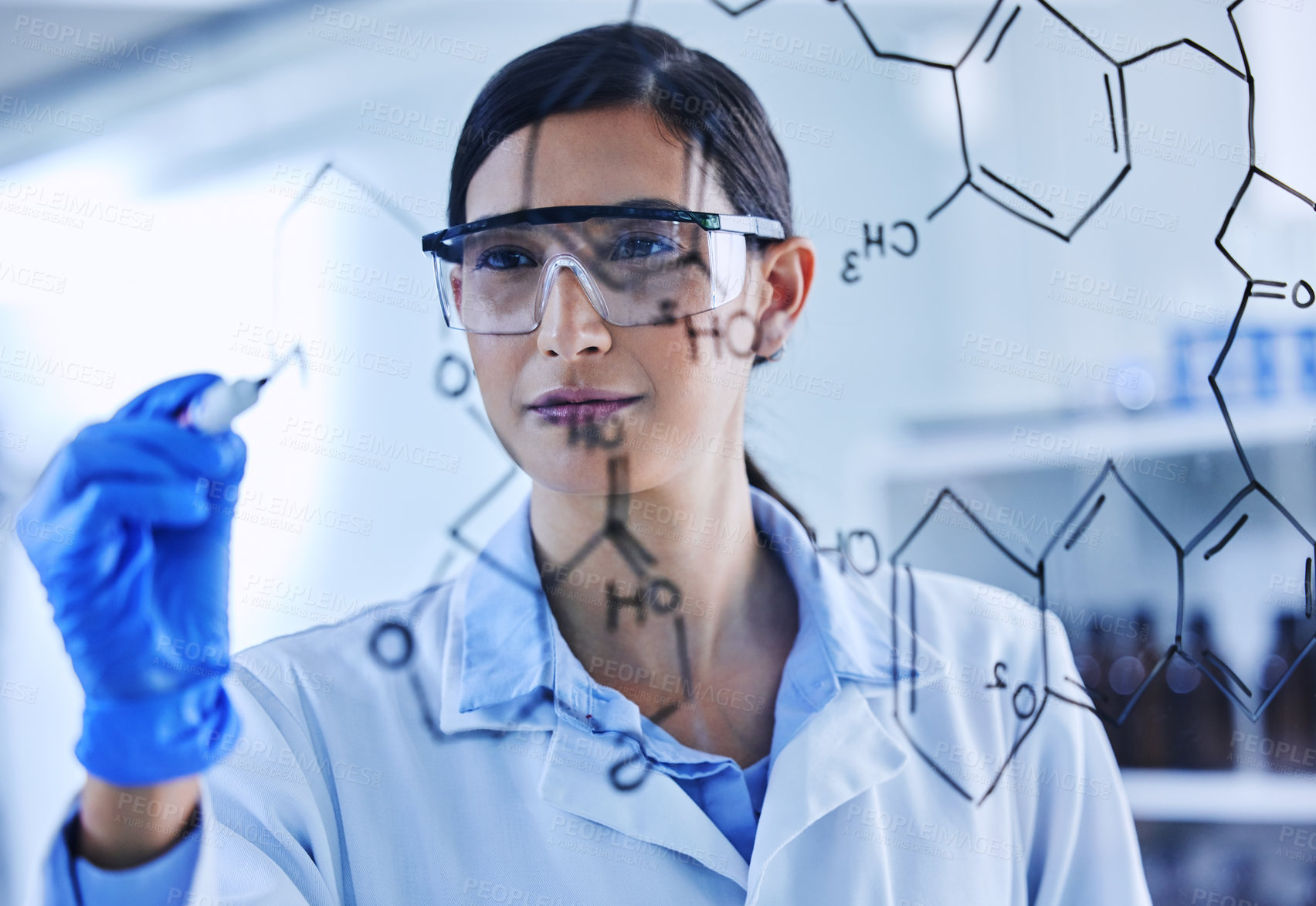 Buy stock photo Cropped shot of an attractive young female scientist working on a glass wipe board in her lab