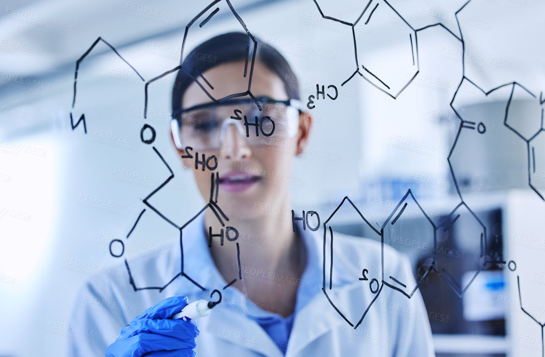 Buy stock photo Cropped shot of an attractive young female scientist working on a glass wipe board in her lab