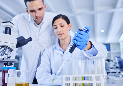 Buy stock photo Cropped shot of two young scientists working together in their lab