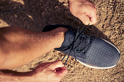 Buy stock photo Top view, hands and runner tie shoes outdoor to start running, exercise or workout. Hand, athlete and man tying sneakers to get ready for cardio, training or exercising for sports, health and fitness