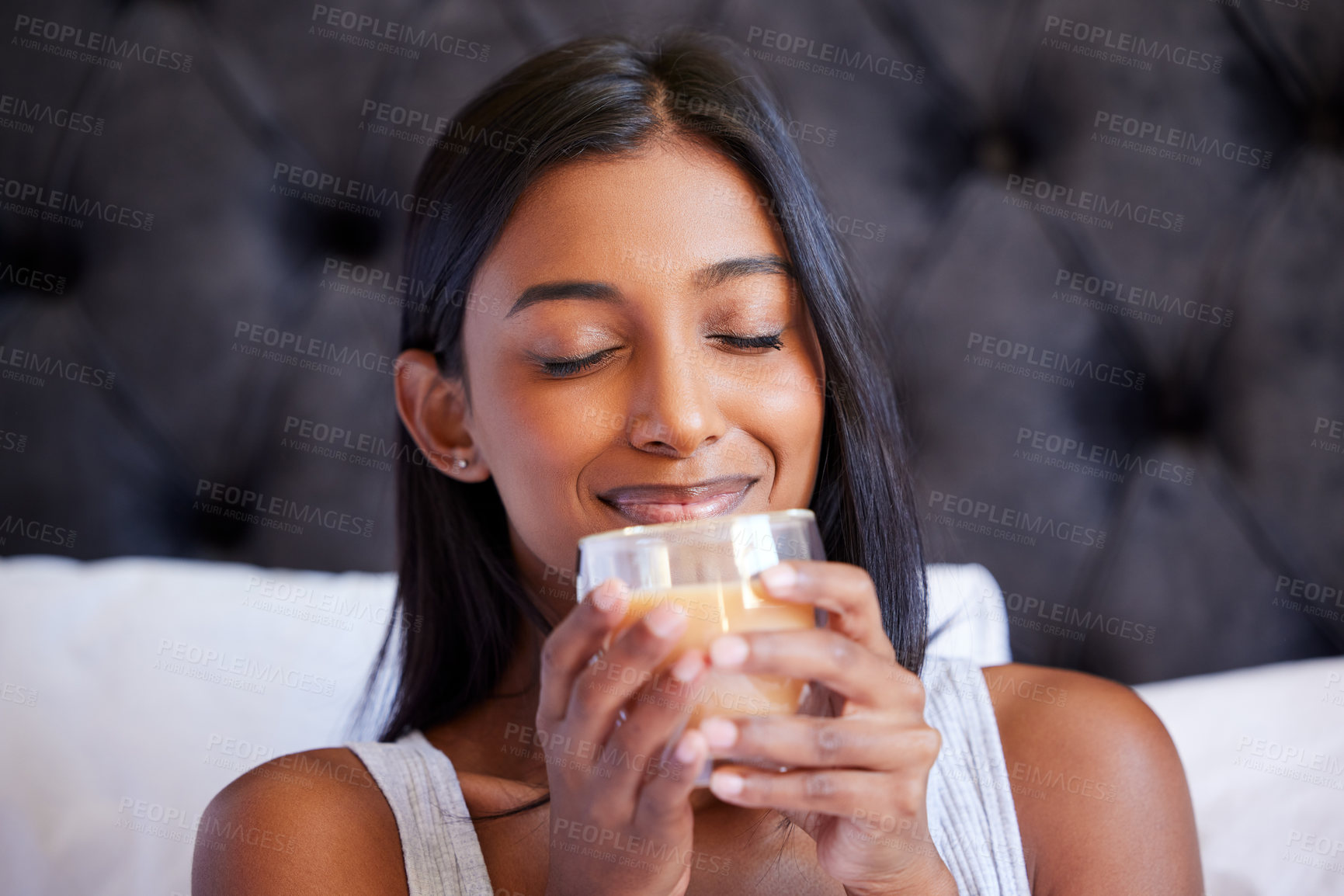 Buy stock photo Woman, smell coffee and peace in bed for morning drink, routine and caffeine aroma for stress relief and calm. Hot beverage, glass cup with spice tea and fragrance for flavor, wellness and self care