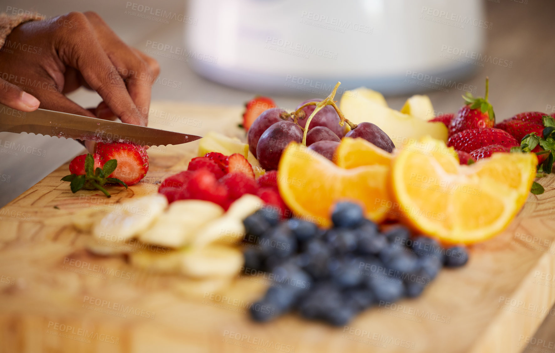 Buy stock photo Closeup shot of an unrecognisable woman cutting fresh fruit at home