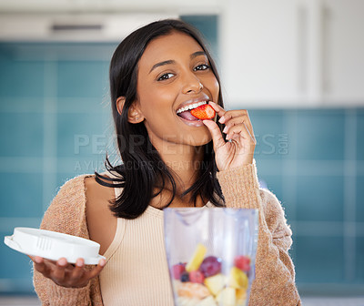 Buy stock photo Woman, eating strawberry and smoothie for detox, blender with fruits for weight loss and nutrition. Fresh, organic and Indian nutritionist and diet, healthy food and portrait with shake for vitamins
