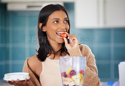 Buy stock photo Indian woman and eating strawberry with blender for smoothie, detox and healthy for diet weight loss and vegan. Fruit, fresh and organic cocktail with kitchen in at home, nutrition and vitamins