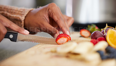 Buy stock photo Closeup shot of an unrecognisable woman cutting fresh fruit at home