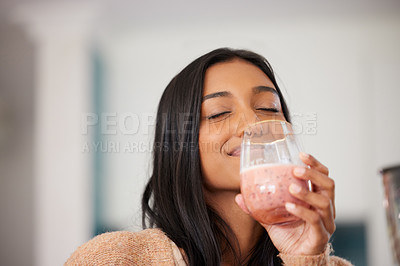 Buy stock photo Indian woman, happy and drinking smoothie for health, nutrition and juice for detox in home. Female person, milkshake and organic ingredients for vegan diet, vitamins and minerals in protein shake