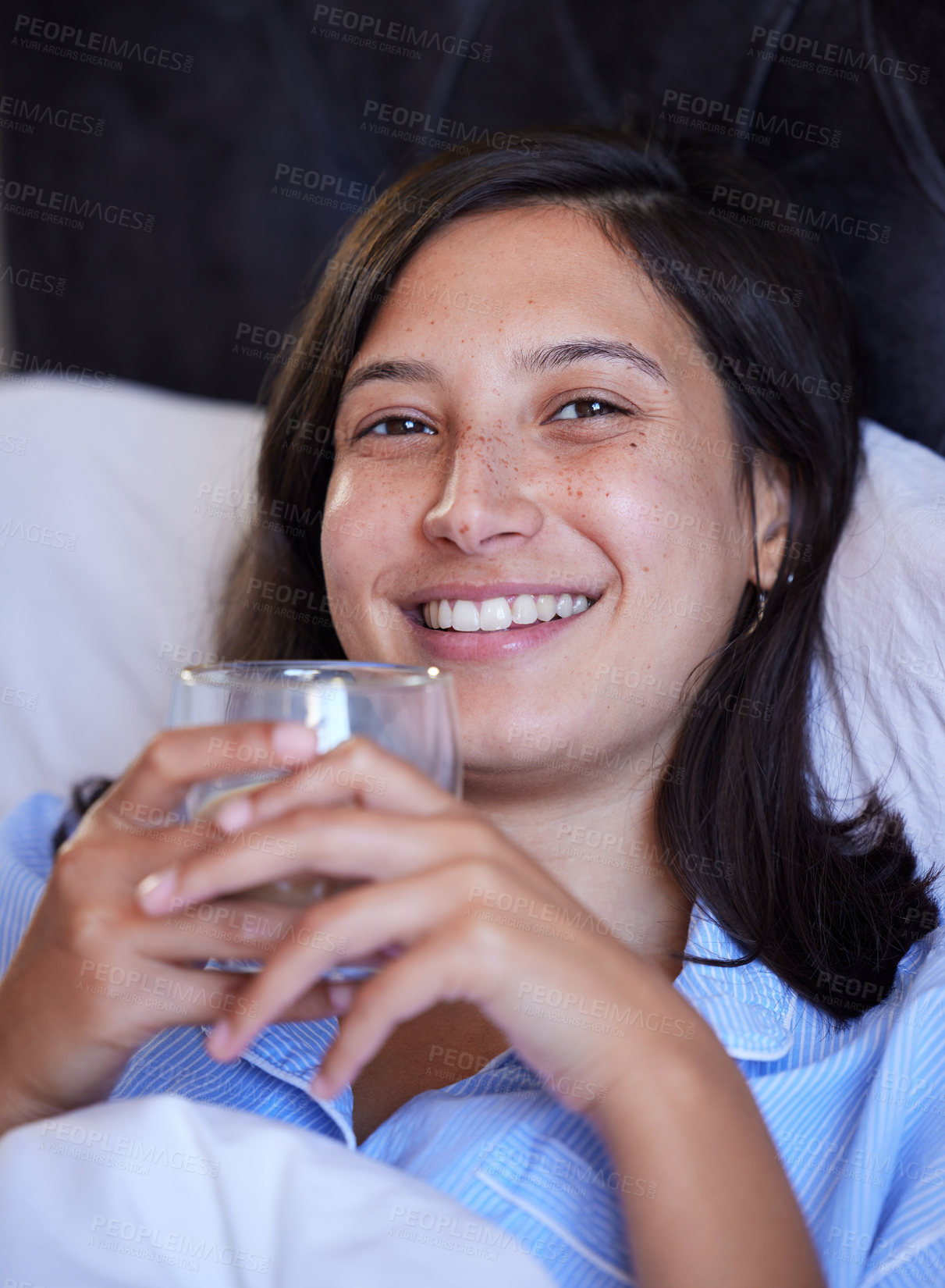 Buy stock photo Woman, tea and portrait in bed, night and happy for wellness, hydration or detox for sleep in home. Girl, person and smile in bedroom with coffee for drink, health and digestion on holiday in Naples