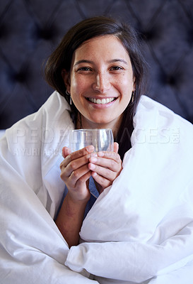 Buy stock photo Woman, water and portrait in bed, smile and relax for wellness, hydration or detox for sleep in home. Girl, person and happy in bedroom with glass for drink, health or digestion on holiday in Naples