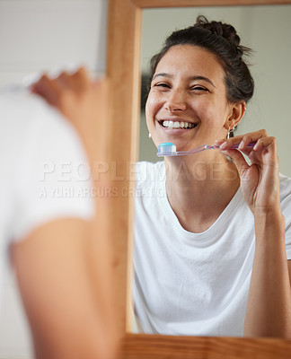 Buy stock photo Woman, toothbrush and smile by mirror in morning to start routine for hygiene, health or oral wellness. Girl, person and toothpaste in reflection to check results, teeth whitening and mouth in home