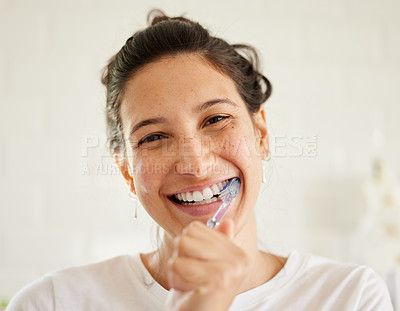Buy stock photo Healthcare, portrait of a woman brush her teeth and smile in her bathroom of her home. Hygiene or self care, health wellness or dental treatment and female person with brushing mouth with toothbrush