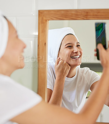 Buy stock photo Shot of a young woman taking a selfie during her morning routine