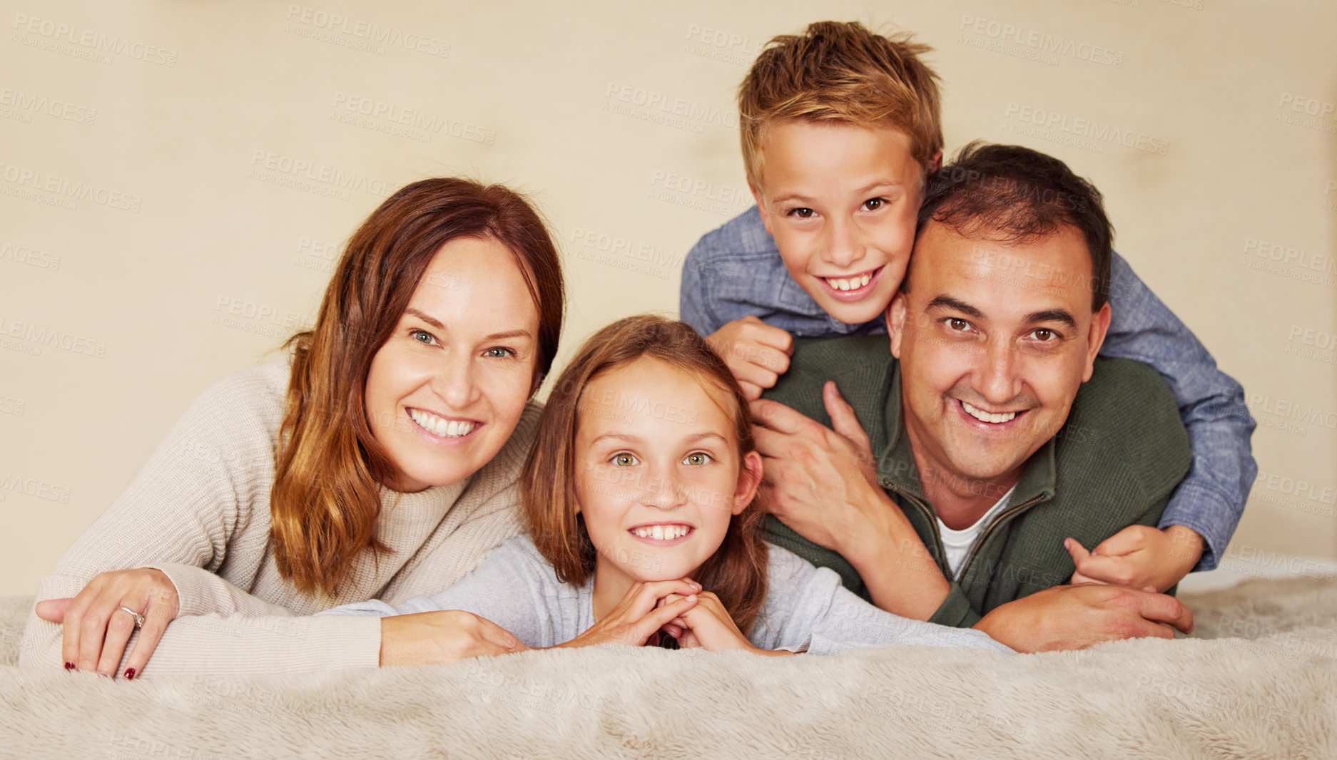 Buy stock photo Happy, family and children in portrait on bed to relax, peace and love at home in bedroom. Connection, smile and people in house or apartment for holiday, vacation or together with hug in Spain