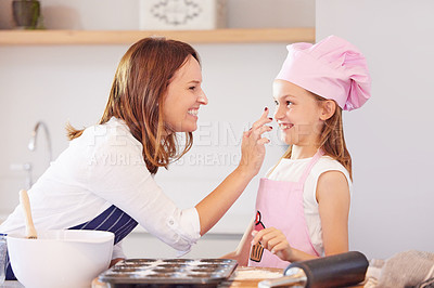 Buy stock photo Mother, girl and nose touch for baking in kitchen, support and child learning to prepare cupcakes. Happy daughter, mama and pastry education in home, love and bonding while cooking snacks or dessert