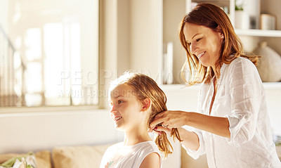 Buy stock photo Mom, girl and hair care in home for grooming with smile, care and love in morning with connection. Hairstyle, mother and daughter with bonding, happy and relax in lounge for hygiene in family house