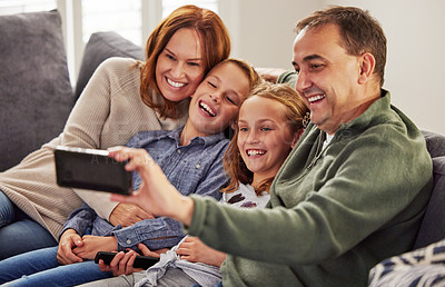 Buy stock photo Happy, family and selfie on sofa in living room for social media, post and memory of vacation. Mother, children and father with digital photography at home for online update, happiness and love