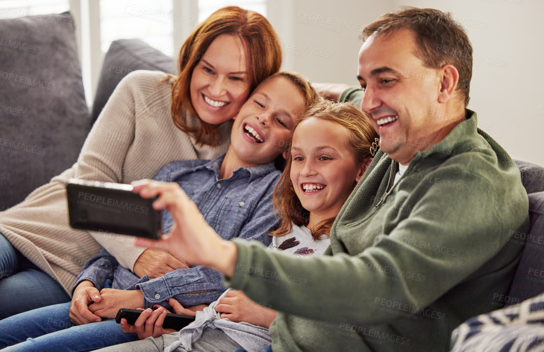 Buy stock photo Happy, family and selfie on sofa in living room for social media, post and memory of vacation. Mother, children and father with digital photography at home for online update, happiness and love