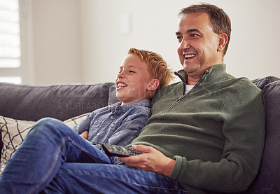 Buy stock photo Funny, man and child together watching tv on sofa, couch and relax at home in living room. Television, movie and people in house or apartment for streaming comedy, video and broadcast in lounge