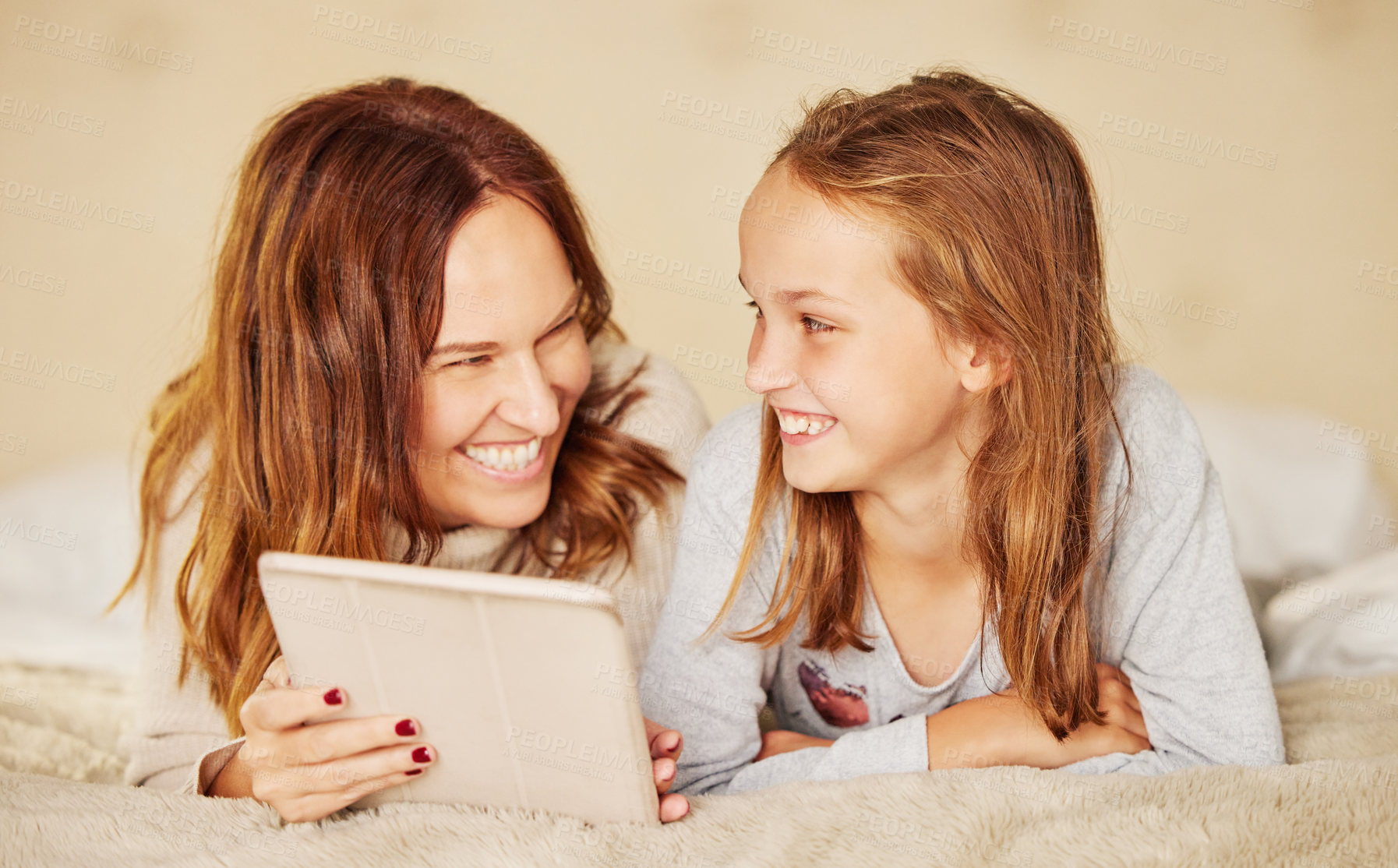 Buy stock photo Mother, girl and tablet for laughing in home, internet and social media for meme or online joke. Mama, daughter and relax on bed for bonding and love, family and streaming comedy movie or series